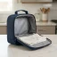 asset_b9142ed78fd5dae5 RTIC Ice Lunch Bag open on a kitchen counter with a damp cloth resting inside its waterproof interior.
